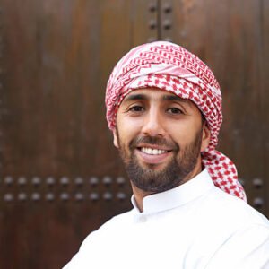 Young smiling handsome arabian man wearing traditional clothes